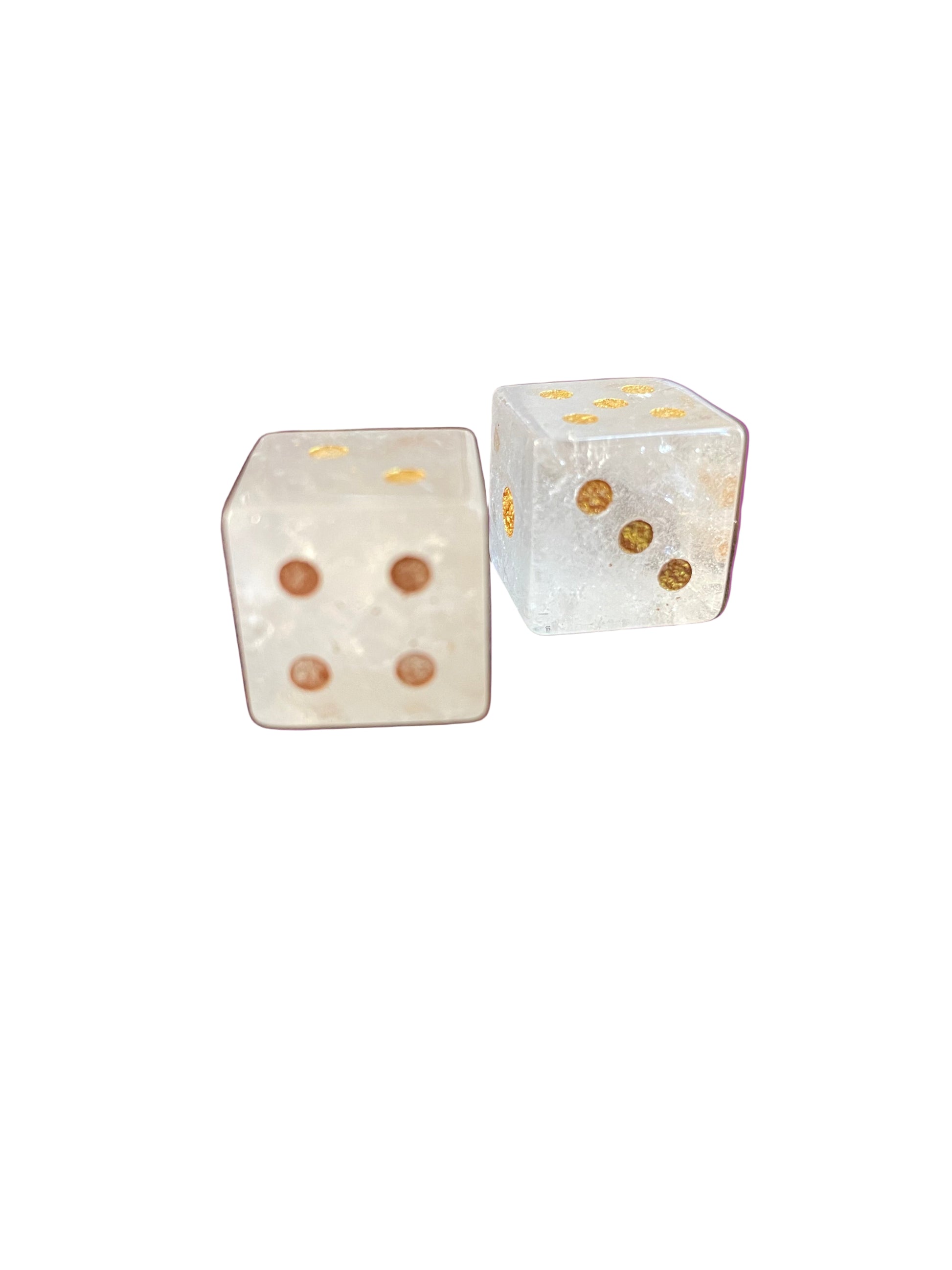 Two clear dice with brown dots on a purple background