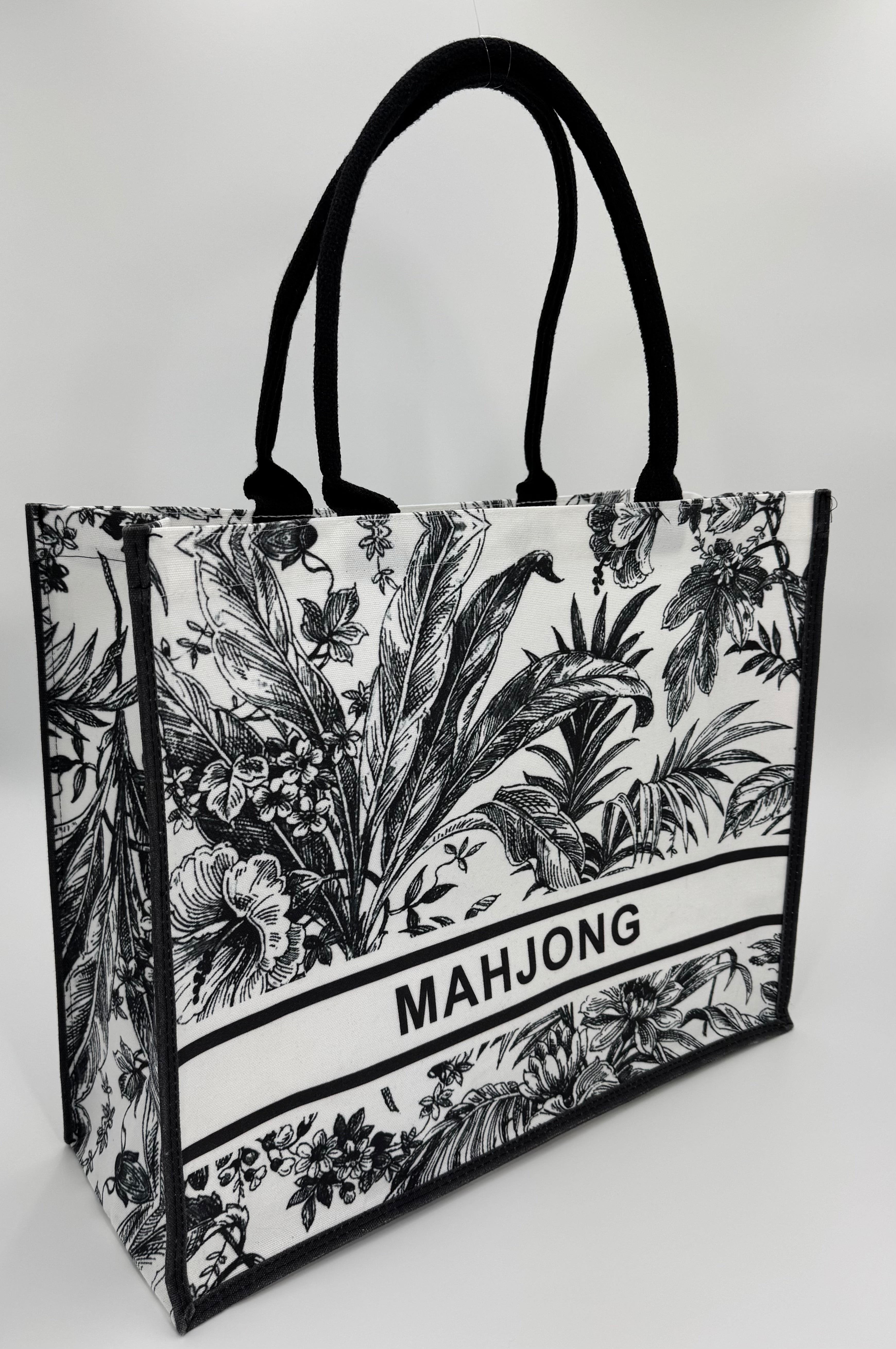 Tote bag with black and white floral design and 'MAHJONG' text on a white background