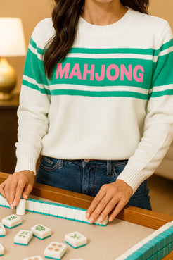 white mahjong sweater with green stripe and collegiate pink lettering spelling Mahjong