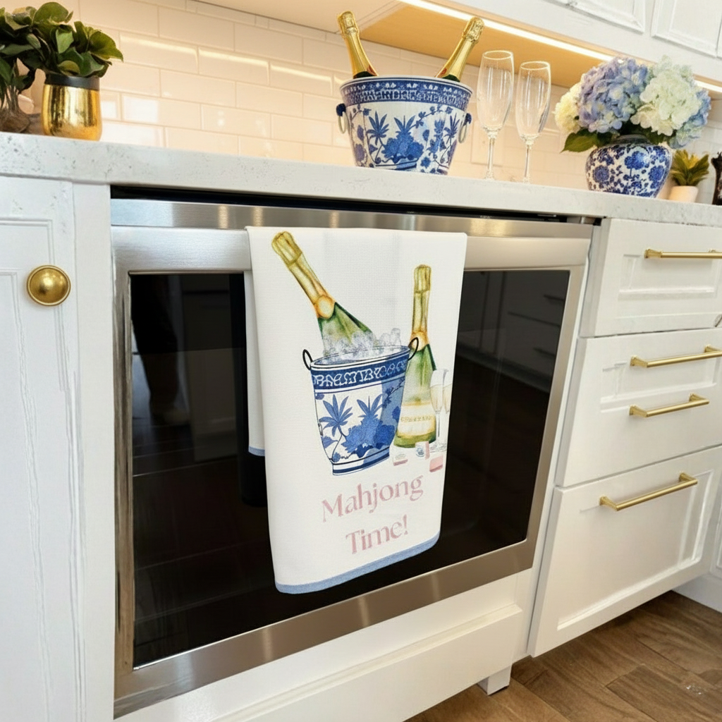 Cotton tea towel with mahjong time printed on t and a bucket of champagne and glasses