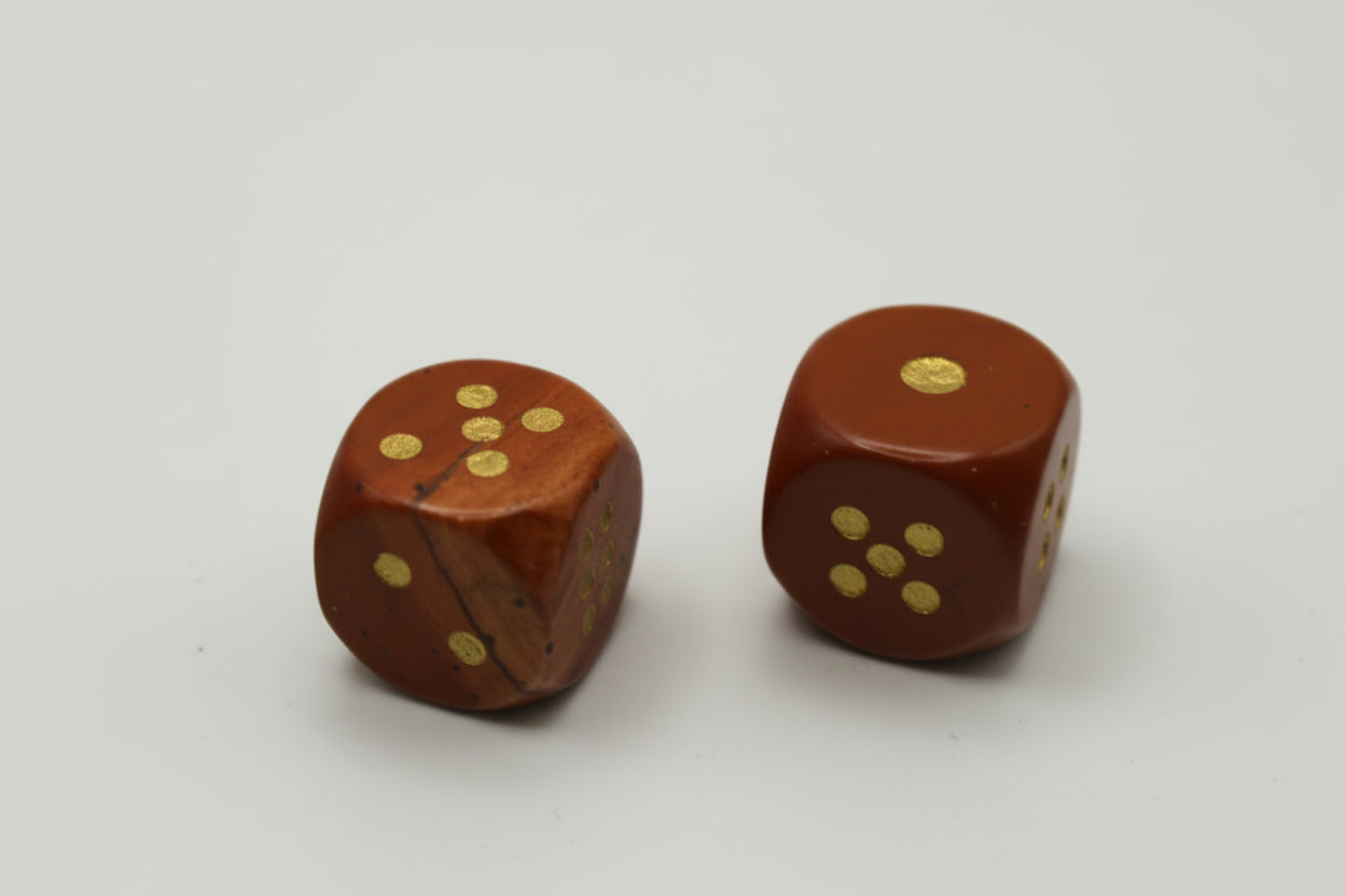 two natural stone red dice