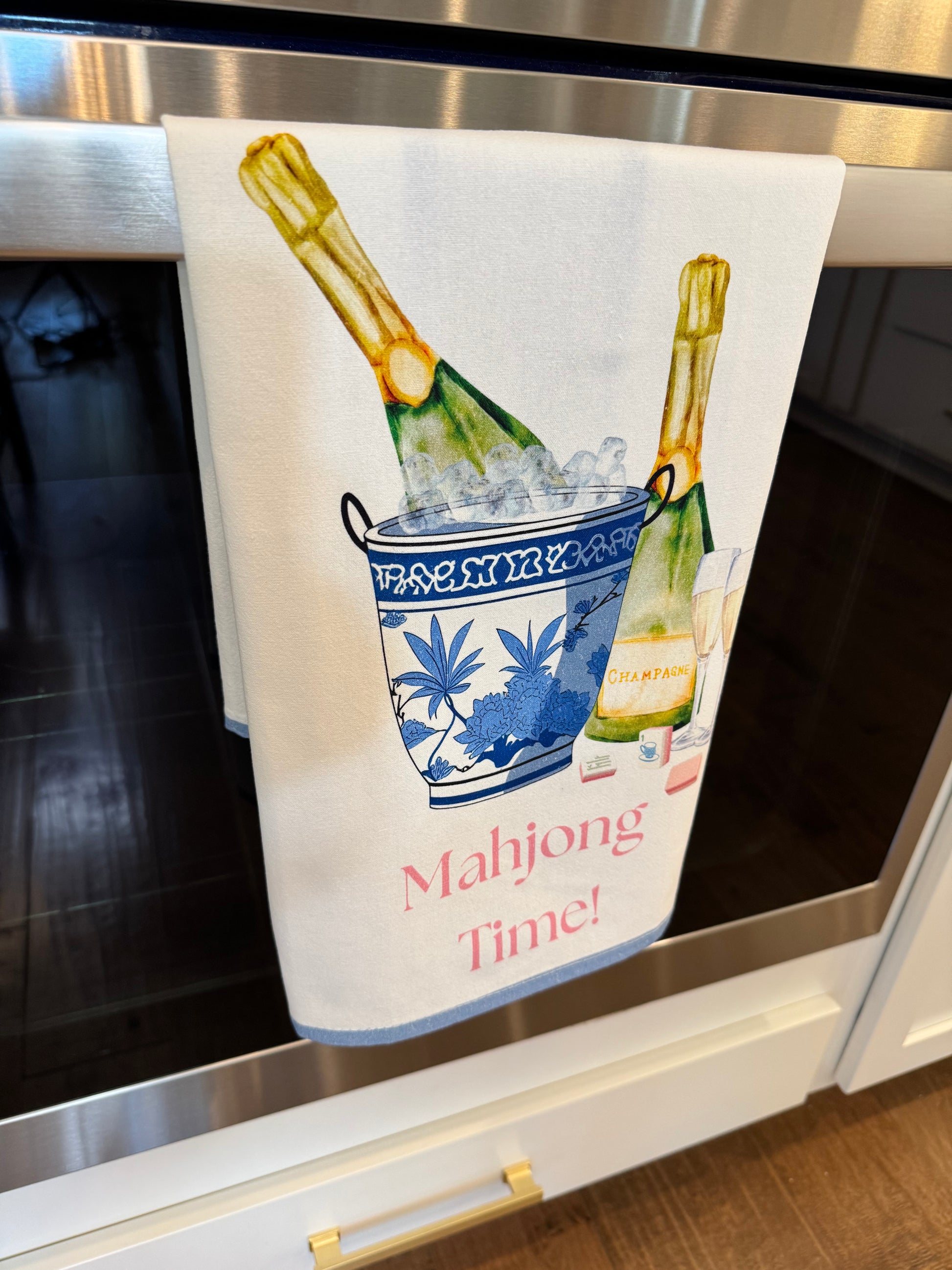 Cotton tea towel with champagne in bucket and glasses and says mahjong time