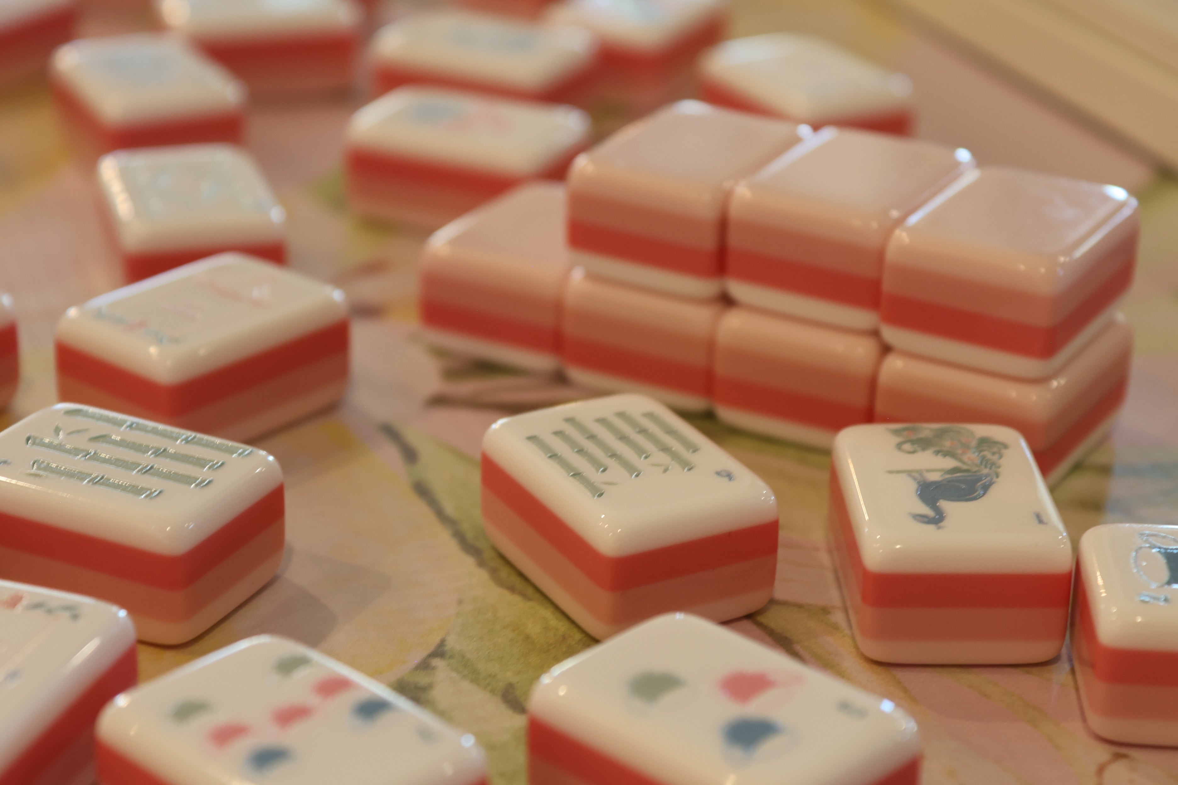 Close-up of pink and white game pieces on a board game surface